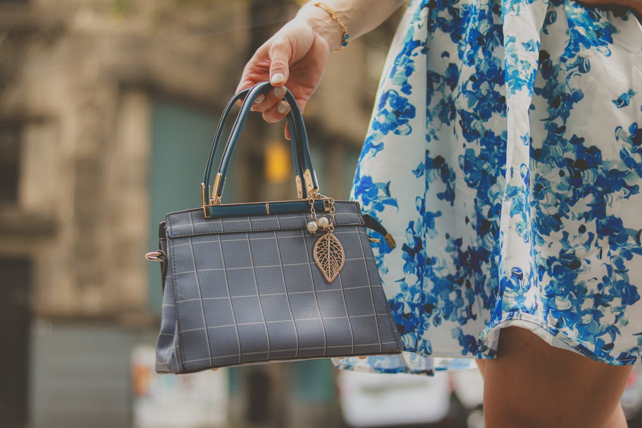 why-choose-us Elegant blue handbag and floral dress detail, perfect for fashion-forward styling on the go.